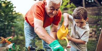 Man helping child in garden