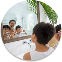 Parent and children brushing teeth