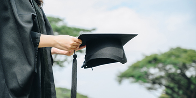 Student holding graduation cap