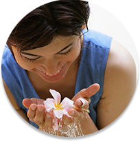 Woman smiling down at tropical flower