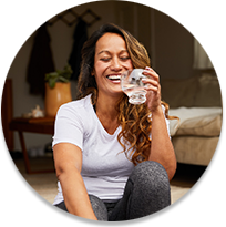 Woman laughing with a glass of water in her hand